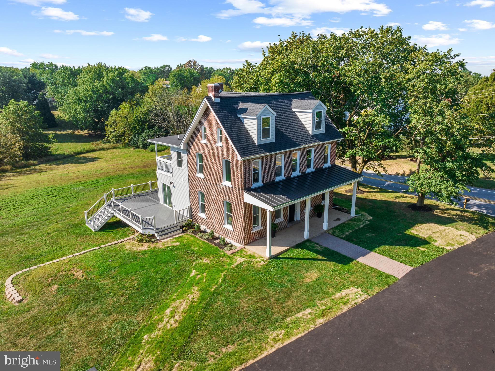 an aerial view of a house with a big yard