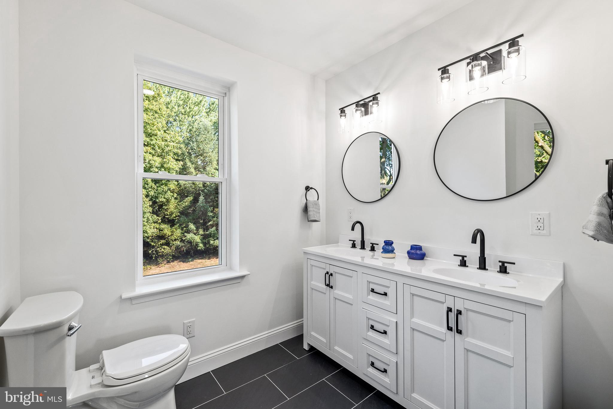 2055 Allentown Road Hatfield, PA 19440 - Photo 19 of 43 a bathroom with a toilet a sink and a mirror