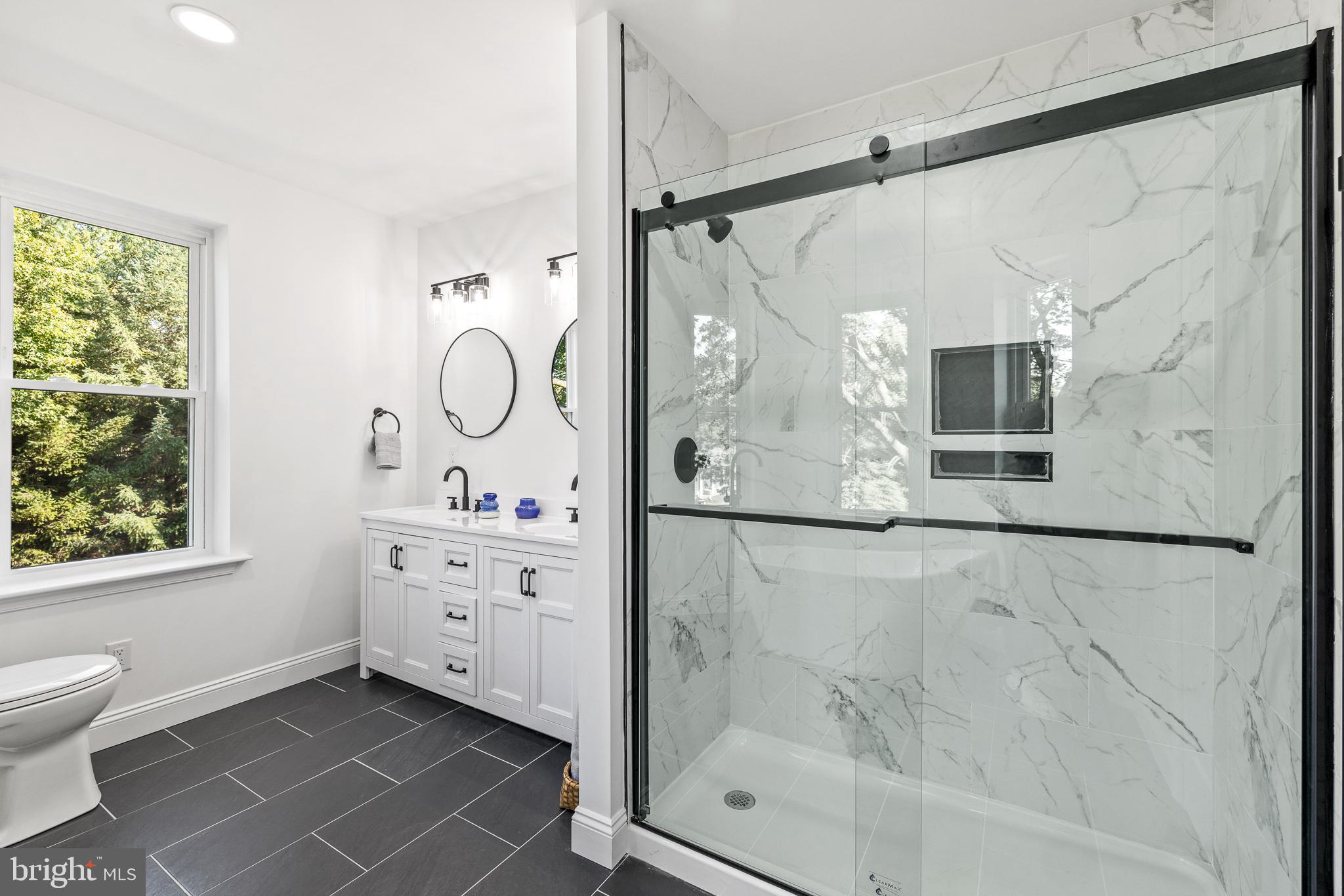 2055 Allentown Road Hatfield, PA 19440 - Photo 20 of 43 a bathroom with a granite countertop sink a mirror and a shower