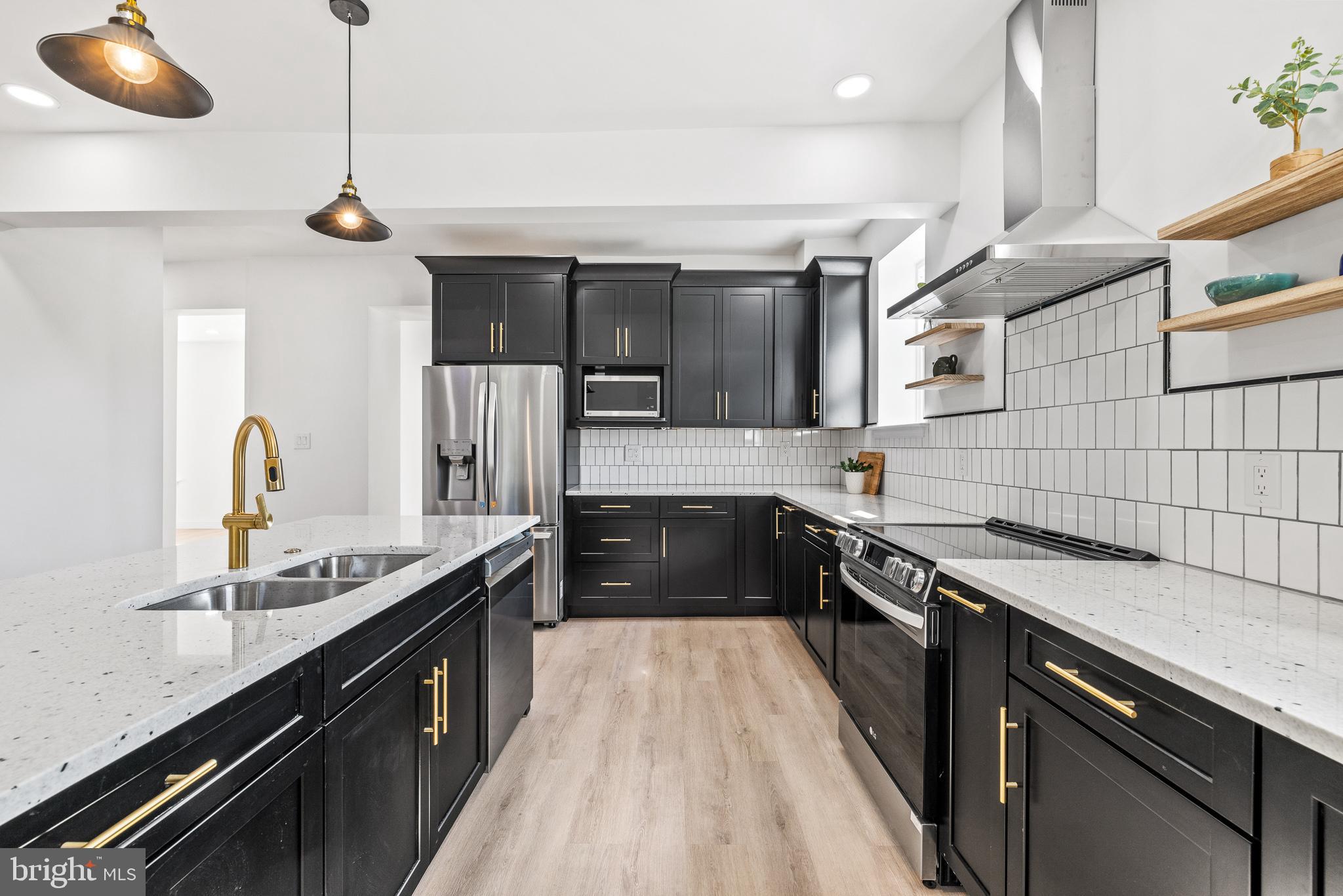 2055 Allentown Road Hatfield, PA 19440 - Photo 5 of 43 a kitchen with stainless steel appliances granite countertop a sink a stove and a wooden floor
