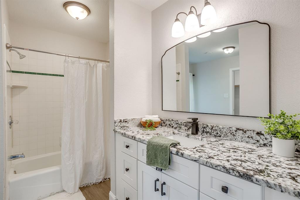 1003 Canton Road Cleburne, TX 76033 - Photo 21 of 40 a bathroom with a sink and a mirror