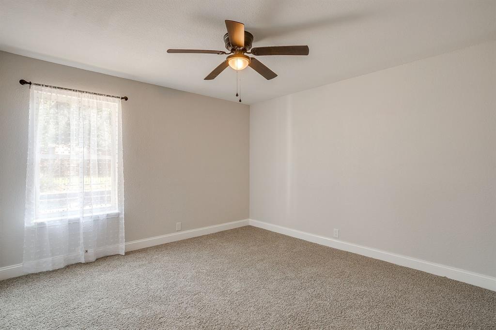 1003 Canton Road Cleburne, TX 76033 - Photo 26 of 40 an empty room with a window and a fan
