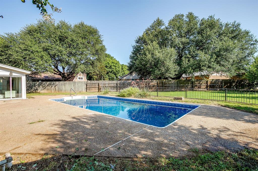 1003 Canton Road Cleburne, TX 76033 - Photo 35 of 40 a view of a swimming pool with a yard