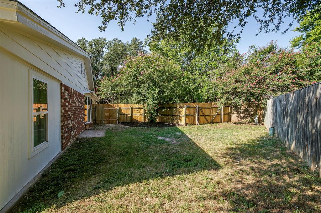 1003 Canton Road Cleburne, TX 76033 - Photo 37 of 40 a front view of a house with a yard and trees