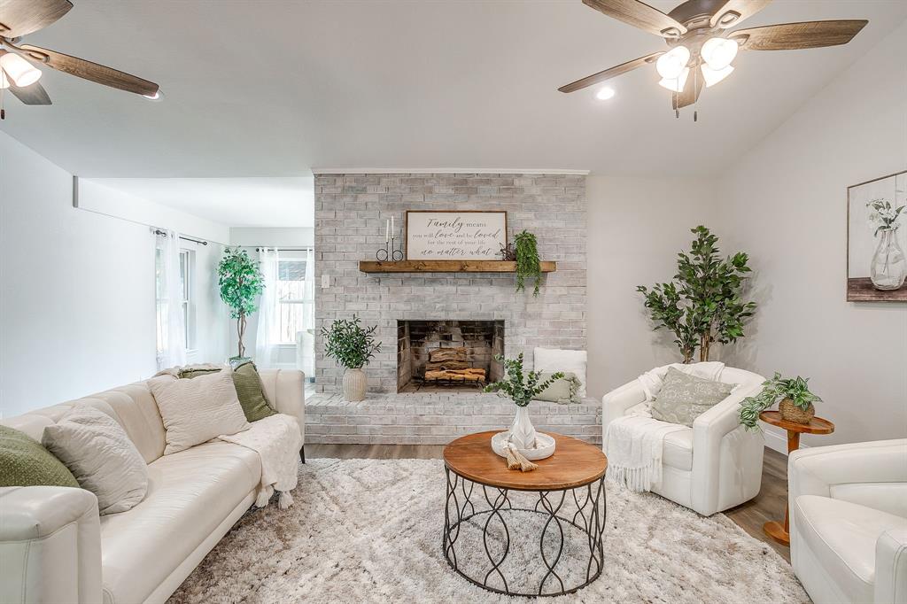 1003 Canton Road Cleburne, TX 76033 - Photo 4 of 40 a living room with furniture and a fireplace