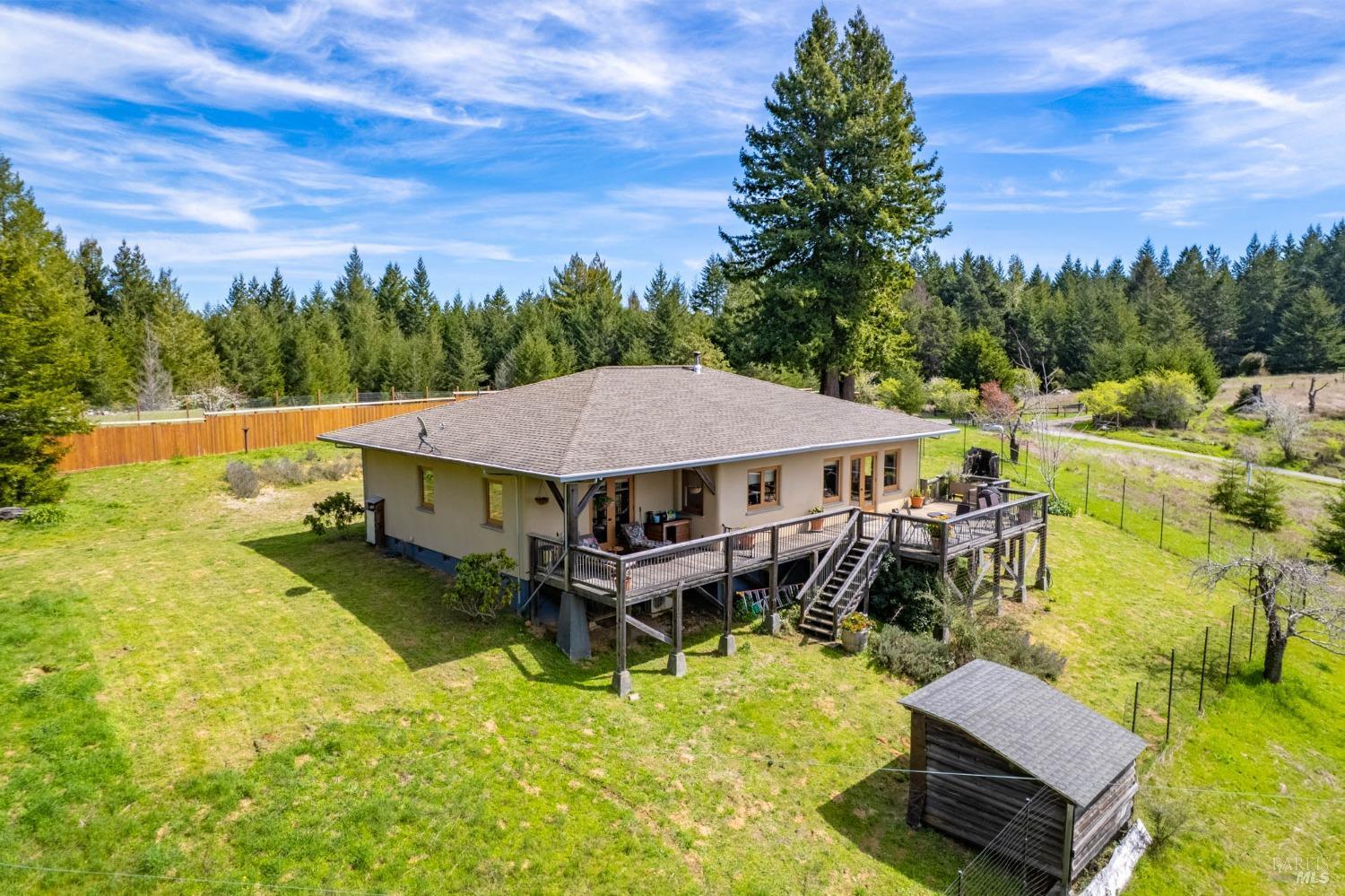a aerial view of a house with swimming pool garden view and trees