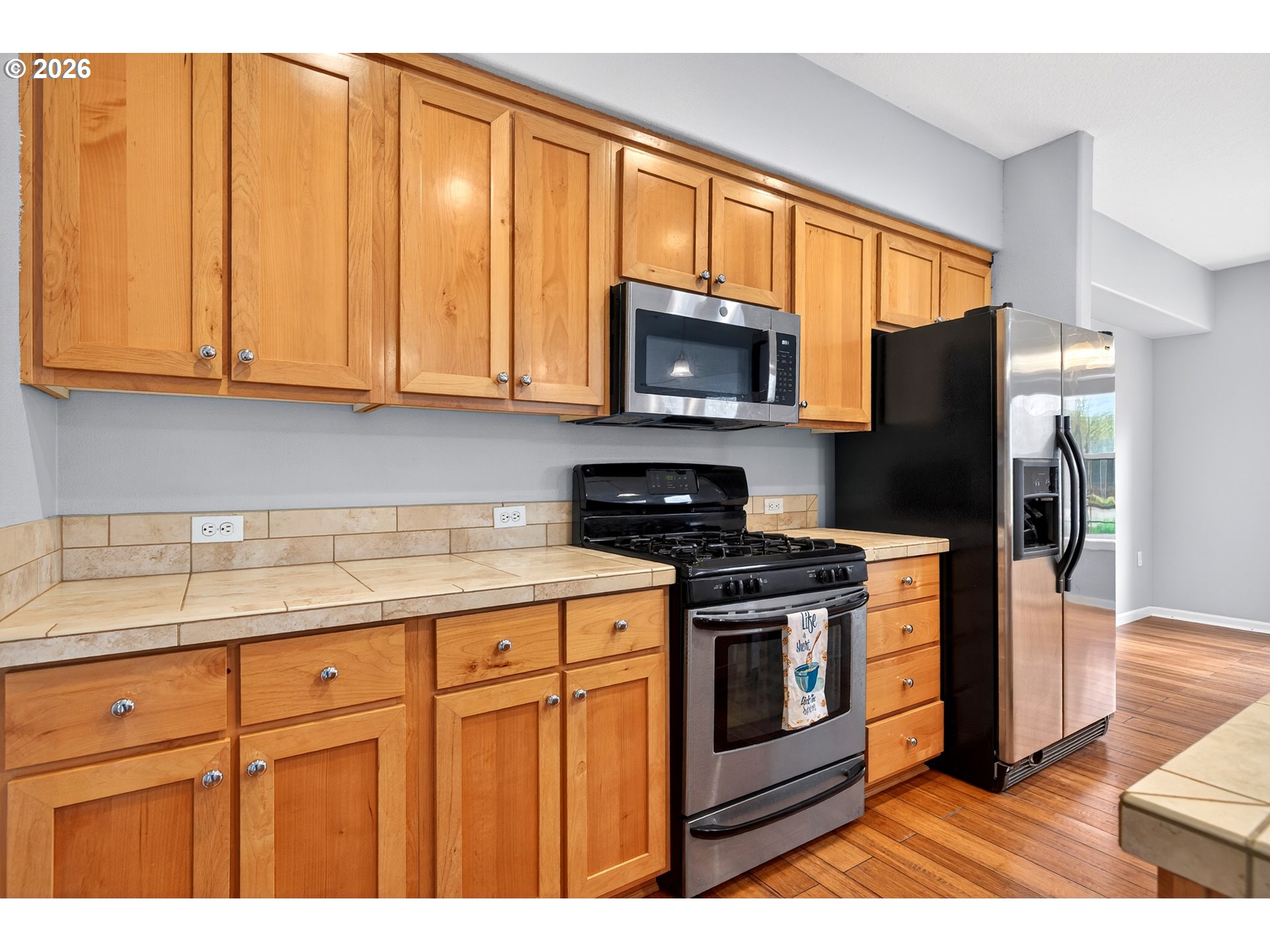 102 Northeast Canvasback Way Hillsboro, OR 97006 - Photo 11 of 36 a kitchen with stainless steel appliances granite countertop a stove a sink dishwasher and a microwave