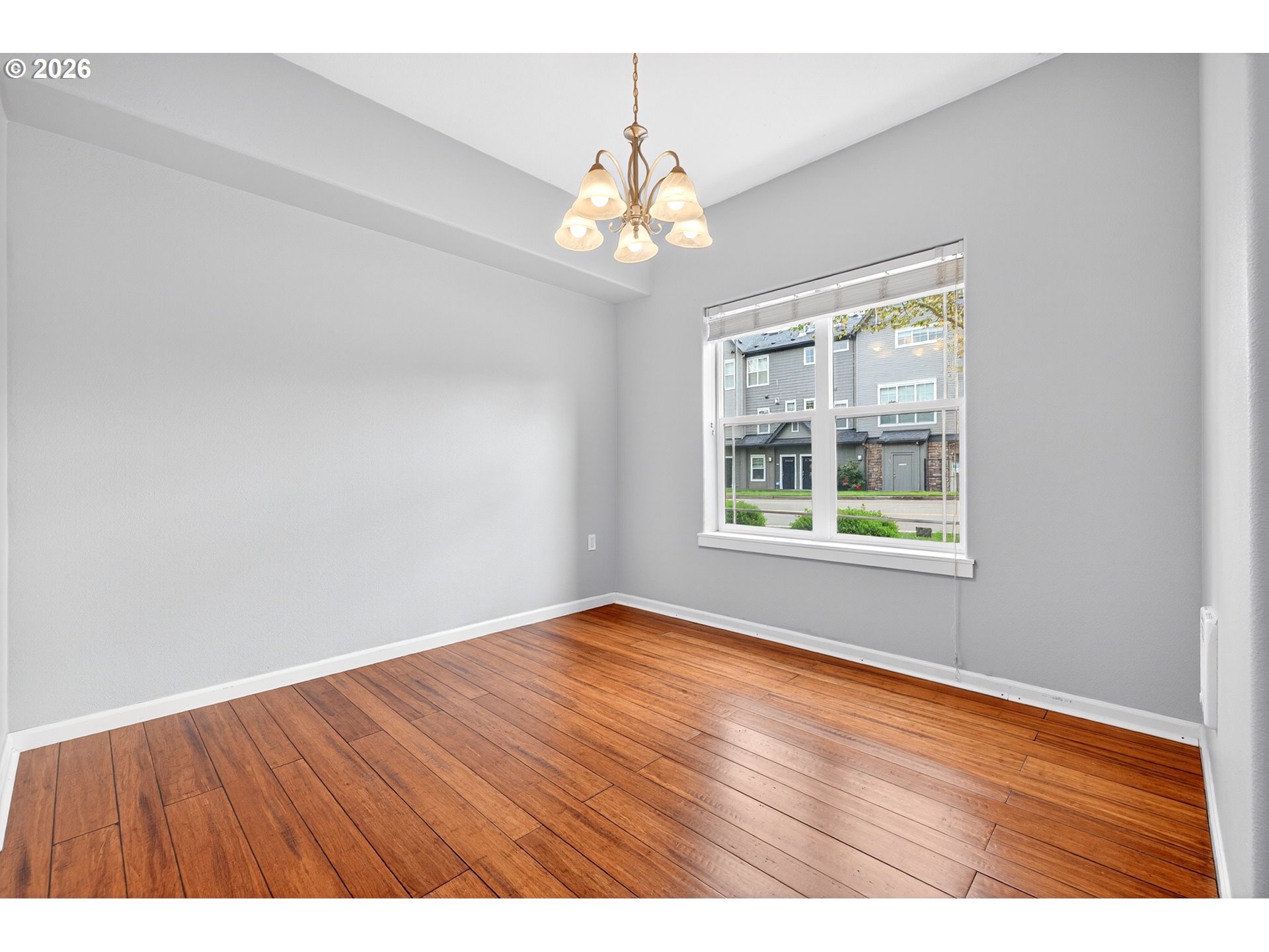 102 Northeast Canvasback Way Hillsboro, OR 97006 - Photo 15 of 36 an empty room with wooden floor and windows