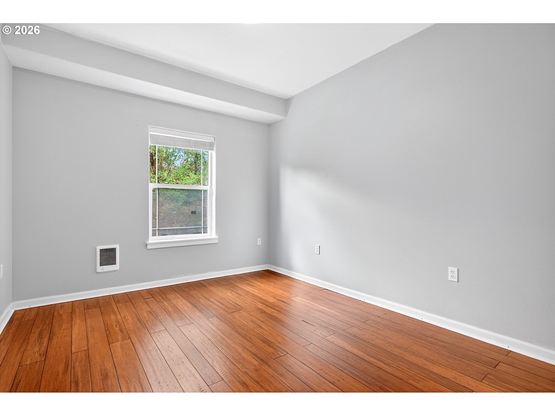 102 Northeast Canvasback Way Hillsboro, OR 97006 - Photo 18 of 36 a view of an empty room with wooden floor and a window