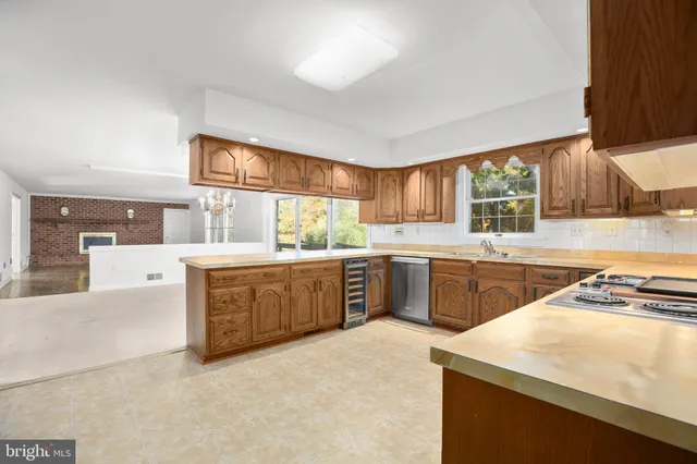 a kitchen with stainless steel appliances granite countertop a refrigerator a sink and dishwasher