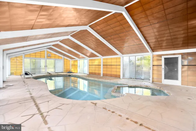 a large bathroom with double vanity and a large window