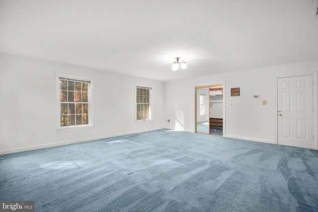 a bathroom with a sink a toilet a mirror and shower