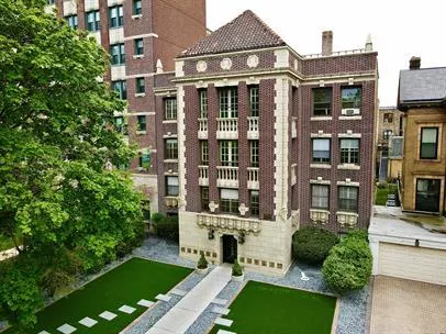 a front view of a residential apartment building with a yard