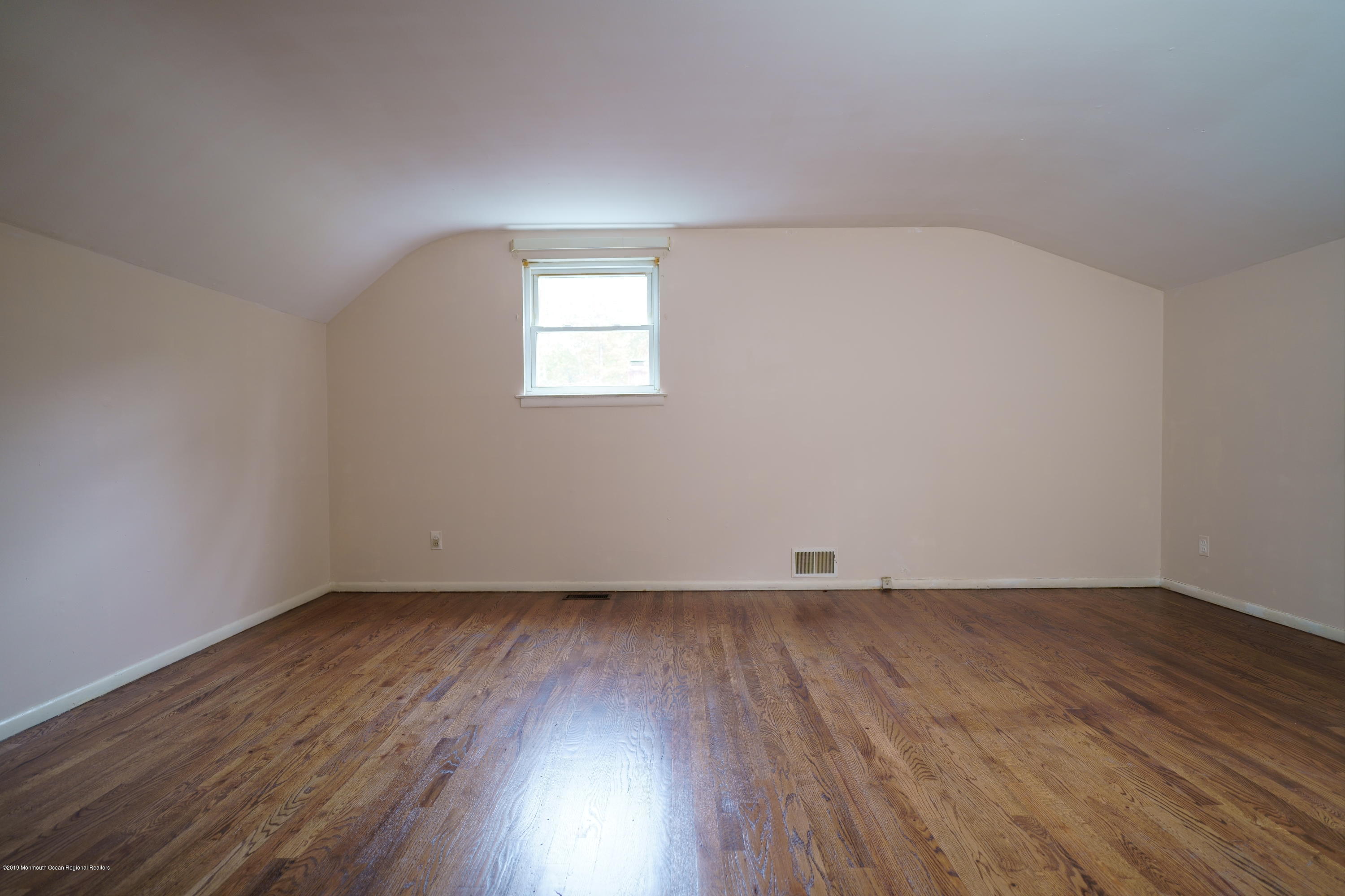 63 Darien Road Howell, NJ 07731 - Photo 13 of 21 an empty room with wooden floor and windows