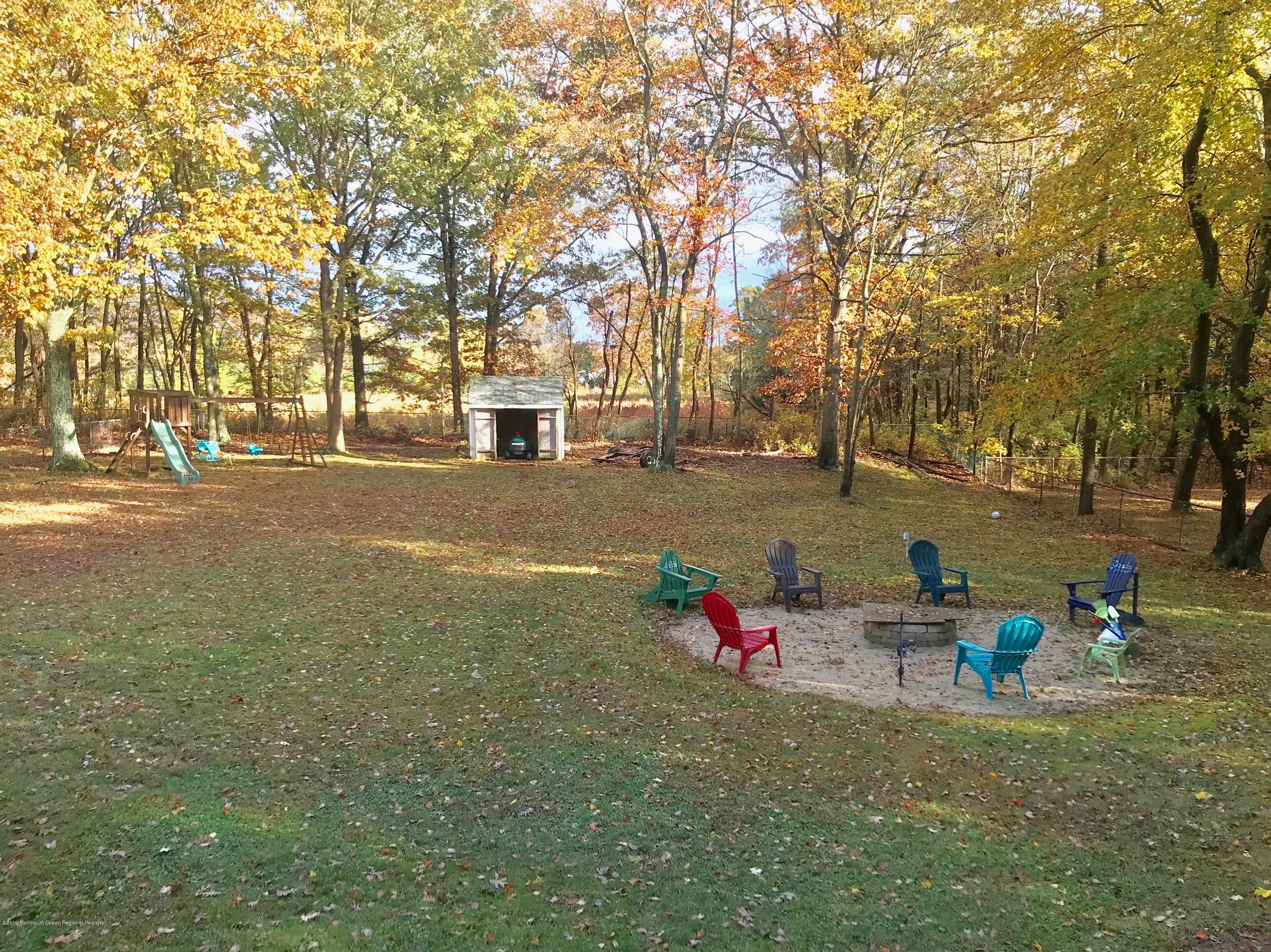 63 Darien Road Howell, NJ 07731 - Photo 19 of 21 a backyard of a house with table and chairs