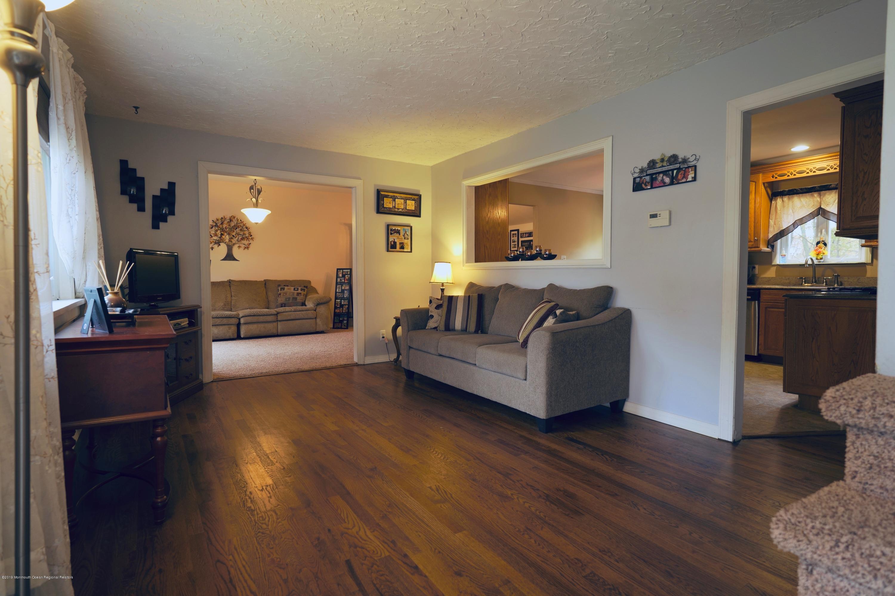 63 Darien Road Howell, NJ 07731 - Photo 3 of 21 a living room with furniture and a wooden floor