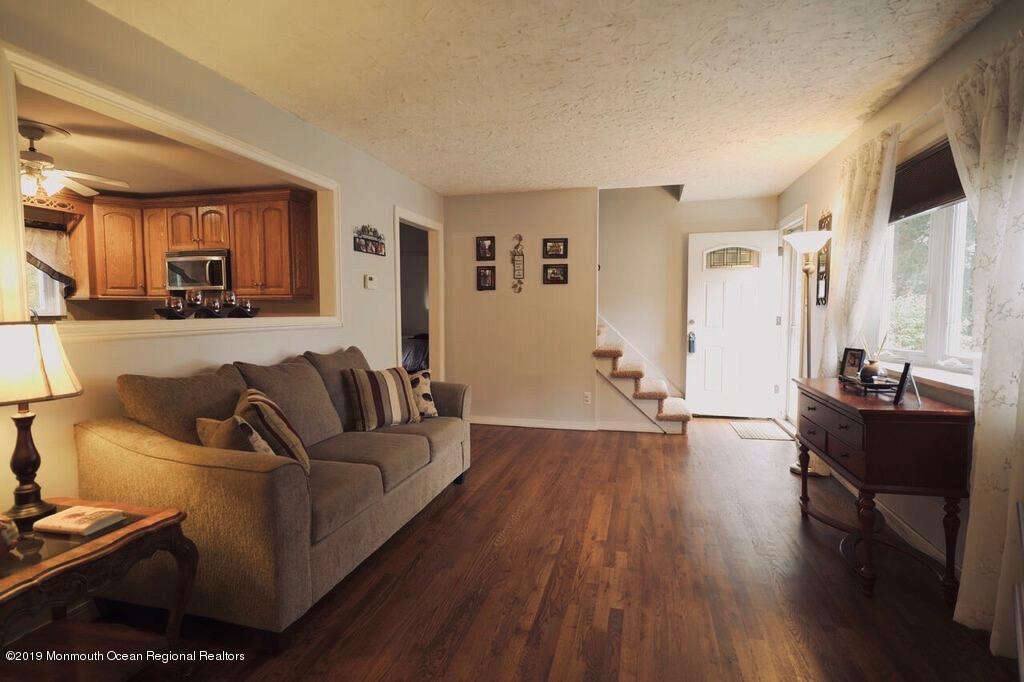 63 Darien Road Howell, NJ 07731 - Photo 4 of 21 a living room with furniture and a wooden floor