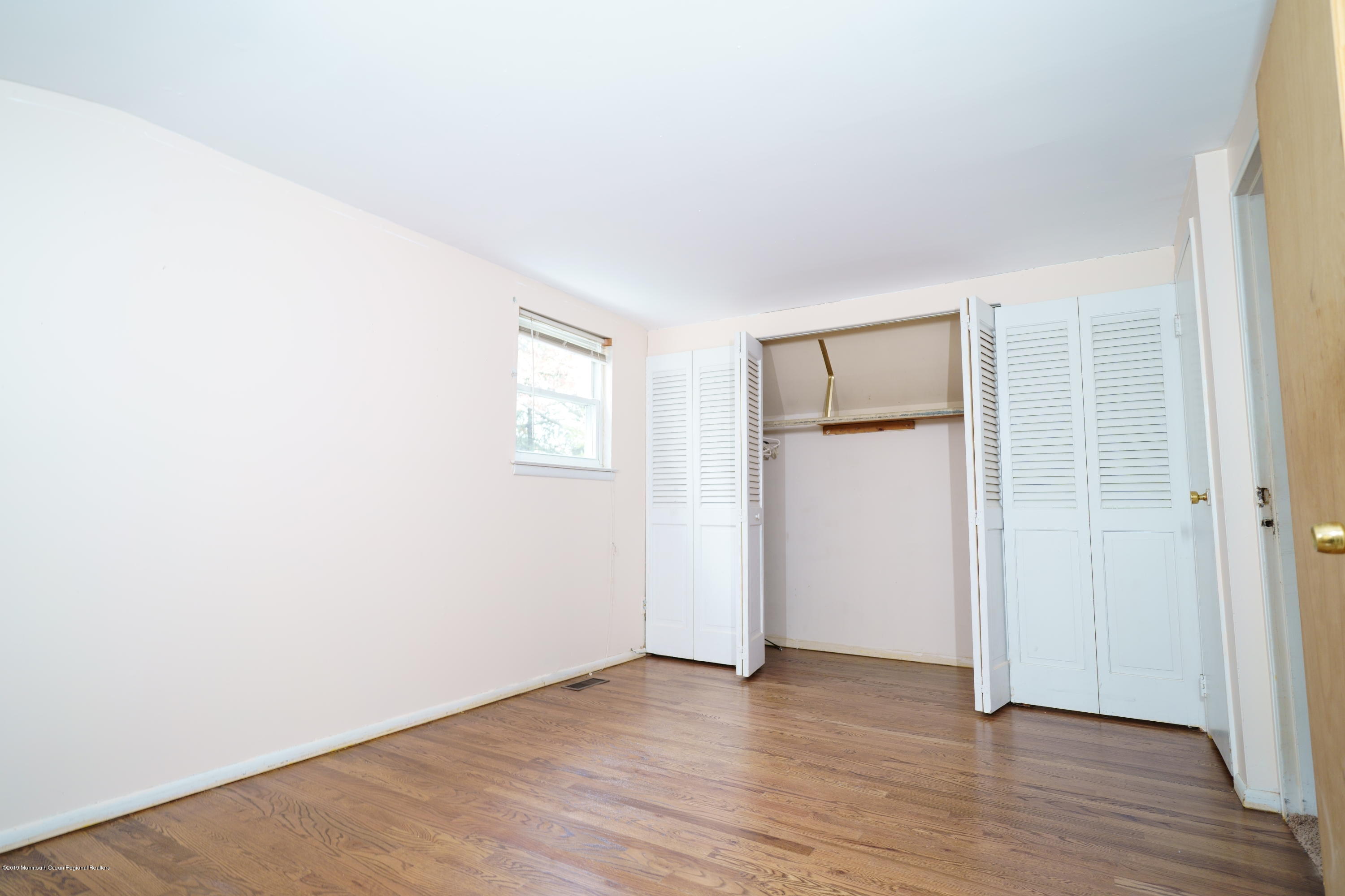 63 Darien Road Howell, NJ 07731 - Photo 10 of 21 an empty room with wooden floor and windows