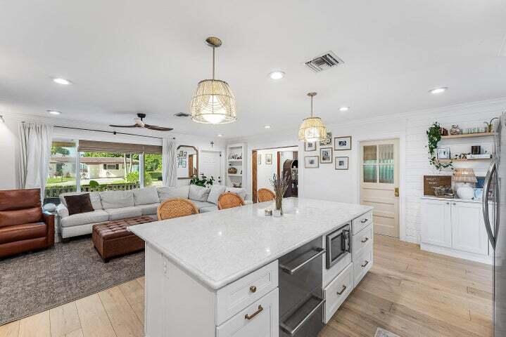 499 Northeast 28th Road Boca Raton, FL 33431 - Photo 14 of 52 a large kitchen with a table and chairs