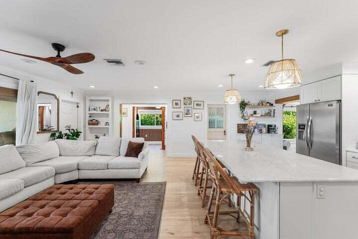 499 Northeast 28th Road Boca Raton, FL 33431 - Photo 16 of 52 a living room with furniture kitchen view and a chandelier