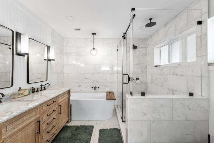 499 Northeast 28th Road Boca Raton, FL 33431 - Photo 24 of 52 a bathroom with a double vanity sink toilet mirror bathtub and shower