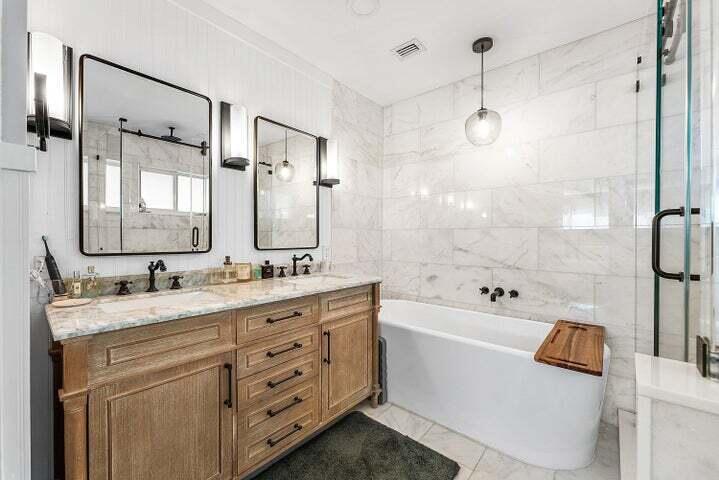 499 Northeast 28th Road Boca Raton, FL 33431 - Photo 25 of 52 a bathroom with a granite countertop sink a mirror a bathtub and shower