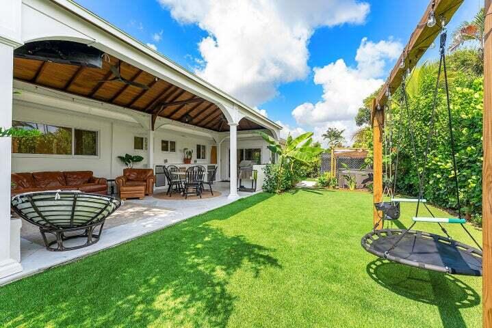 499 Northeast 28th Road Boca Raton, FL 33431 - Photo 38 of 52 a backyard of a house with table and chairs