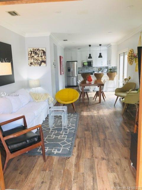 5648 Southwest 5th Terrace Miami, FL 33134 - Photo 2 of 7 a living room with furniture and a dining table