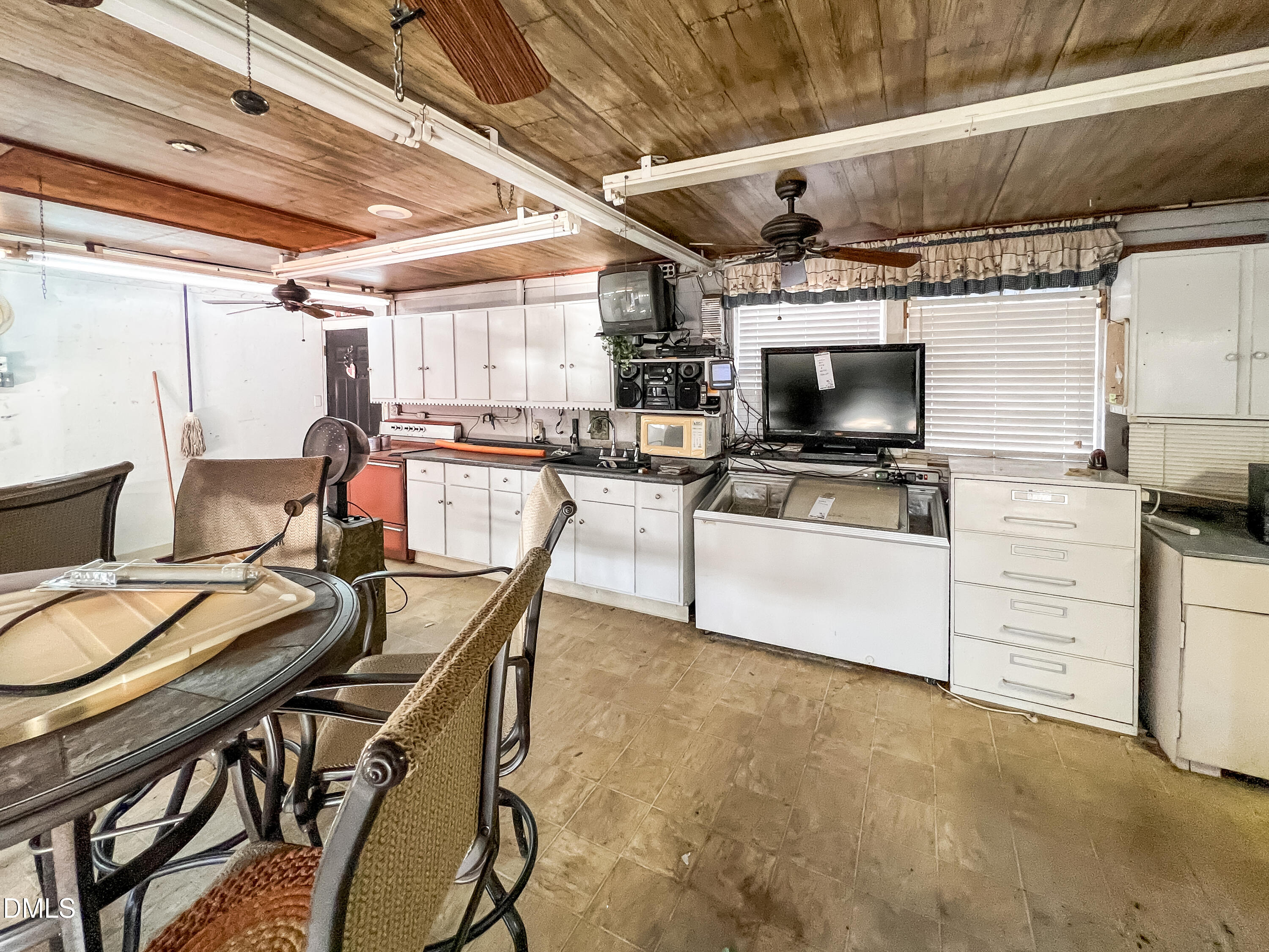 66 Allensville Road Roxboro, NC 27573 - Photo 37 of 52 a kitchen with a table chairs microwave and cabinets