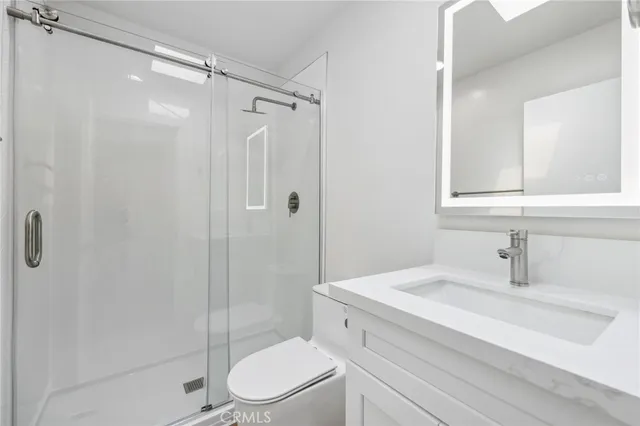 a room with stainless steel appliances wooden floor and a window