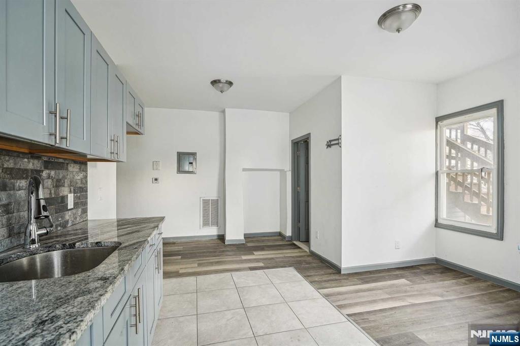143 Valley Road, Unit 1R Montclair, NJ 07042 - Photo 3 of 18 a kitchen with granite countertop a refrigerator and a sink