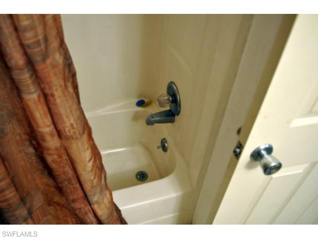 152 Cypress Way East, Unit 7 Naples, FL 34110 - Photo 16 of 21 a bathroom with a sink