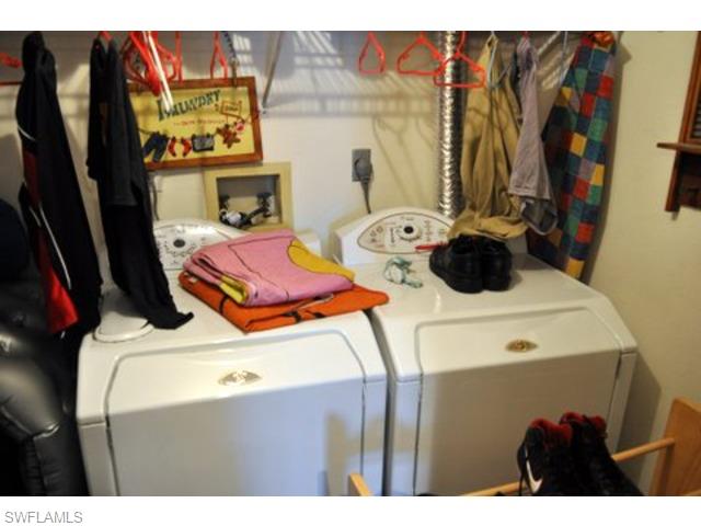 152 Cypress Way East, Unit 7 Naples, FL 34110 - Photo 17 of 21 a utility room with dryer and washer