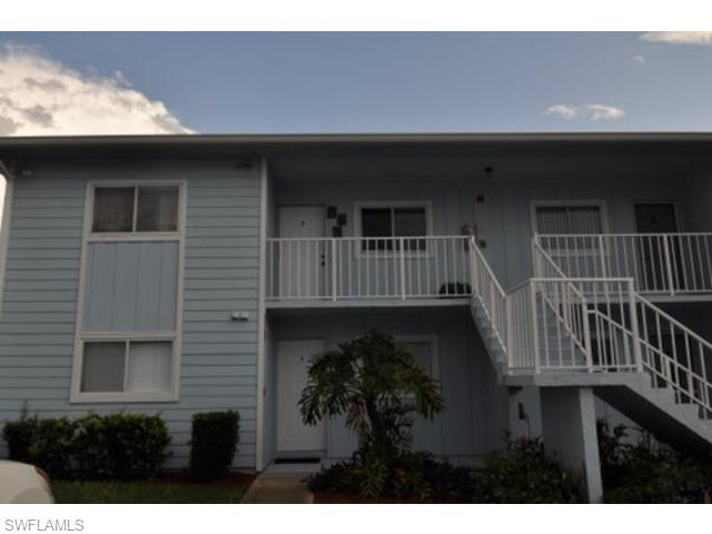 152 Cypress Way East, Unit 7 Naples, FL 34110 - Photo 2 of 21 a front view of a house with balcony
