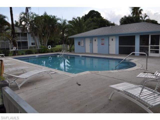 152 Cypress Way East, Unit 7 Naples, FL 34110 - Photo 21 of 21 a view of a house with pool