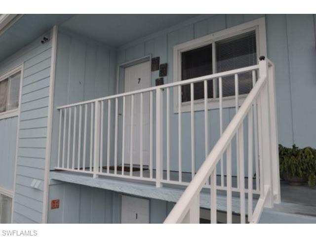 152 Cypress Way East, Unit 7 Naples, FL 34110 - Photo 4 of 21 a view of staircase with wooden floor and stairs