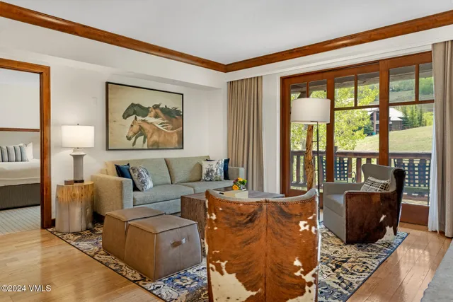 a living room with furniture large window and flat screen tv