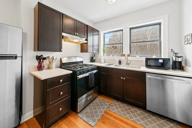 a kitchen with a sink stove and cabinets