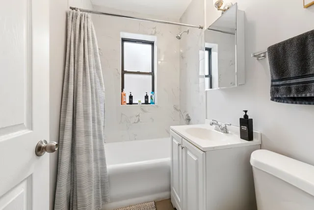 a bathroom with a sink a toilet and a bathtub