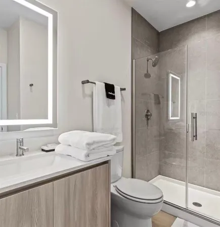 a bathroom with a sink toilet and shower