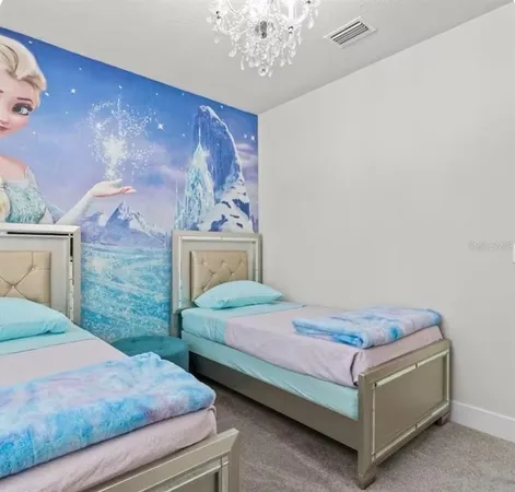 a bedroom with a bed table and chair