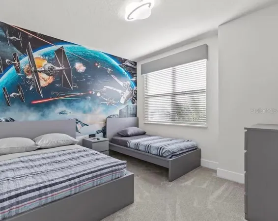 a bedroom with two beds and a window
