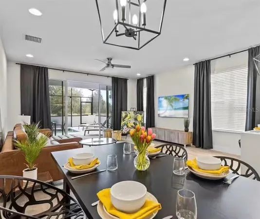 a dining room with furniture and a large window