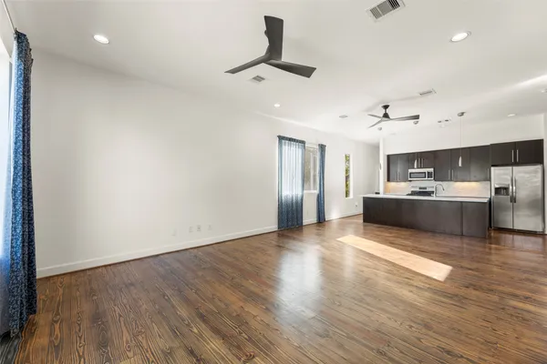 a view of a kitchen with cabinets and wooden floor