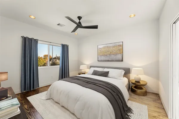 a view of a hallway with wooden floor and closet