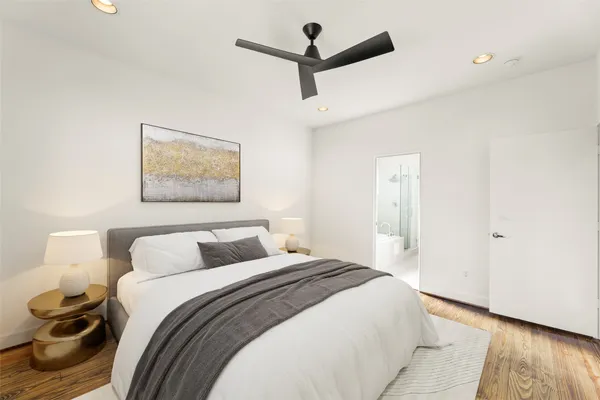 a view of a room with wooden floor and a ceiling fan