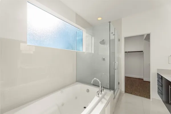 a view of walk in closet with wooden floor