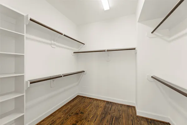 a spacious bathroom with a double vanity sink a mirror and shower