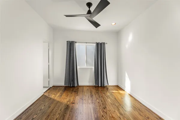 a bathroom with a bathtub shower sink vanity mirror and toilet