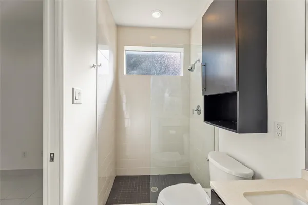 a bathroom with a toilet sink and shower